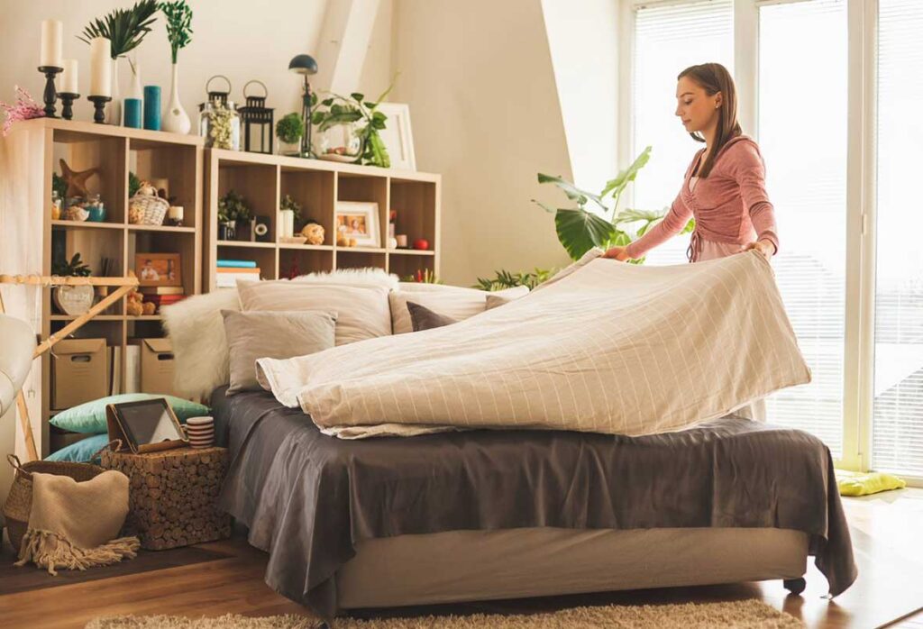 woman deep cleaning her bedroom