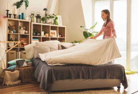 woman deep cleaning her bedroom