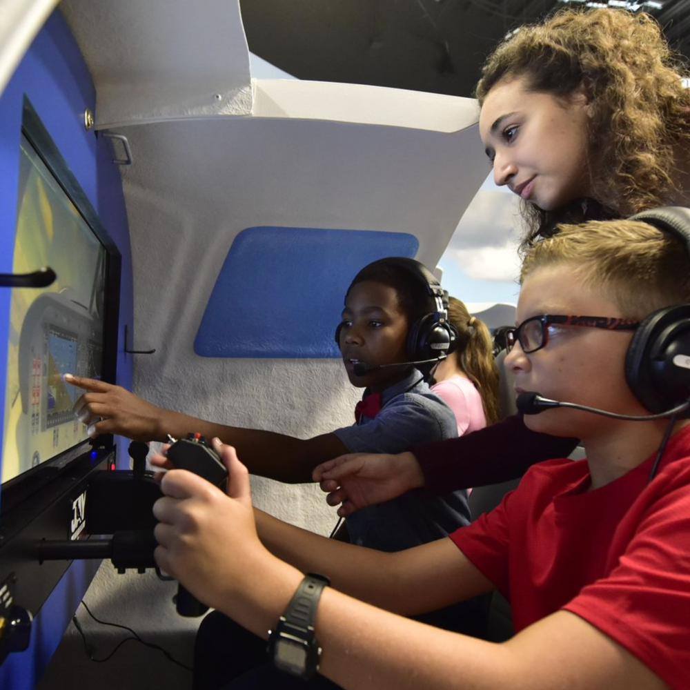 kids playing on flight simulator