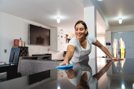 Residential cleaning team polishing a modern kitchen island in an Oakland home.