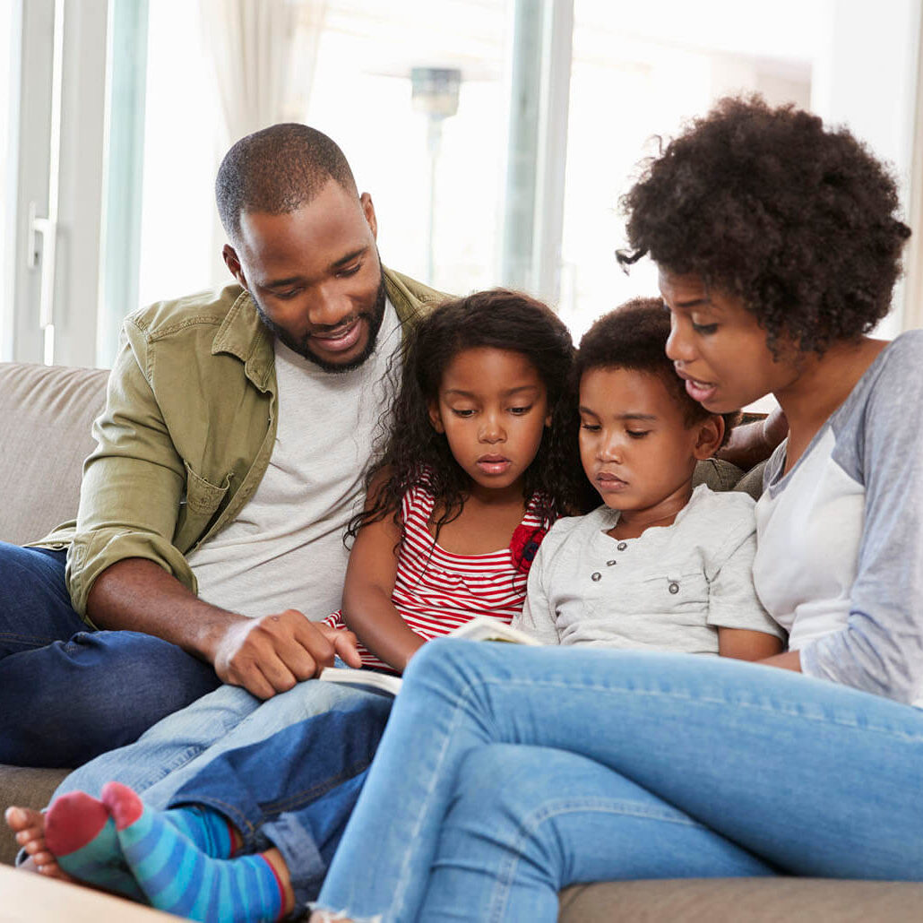 family sitting on the couch together with our great house cleaning services in Emeryville, CA
